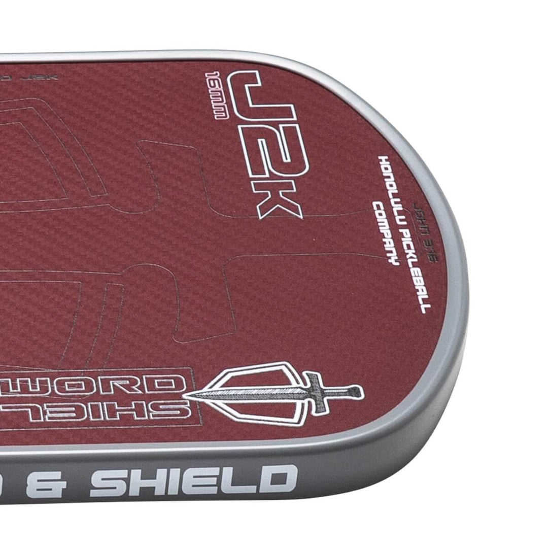 Close-up of a pickleball paddle with branding and design details on a white background