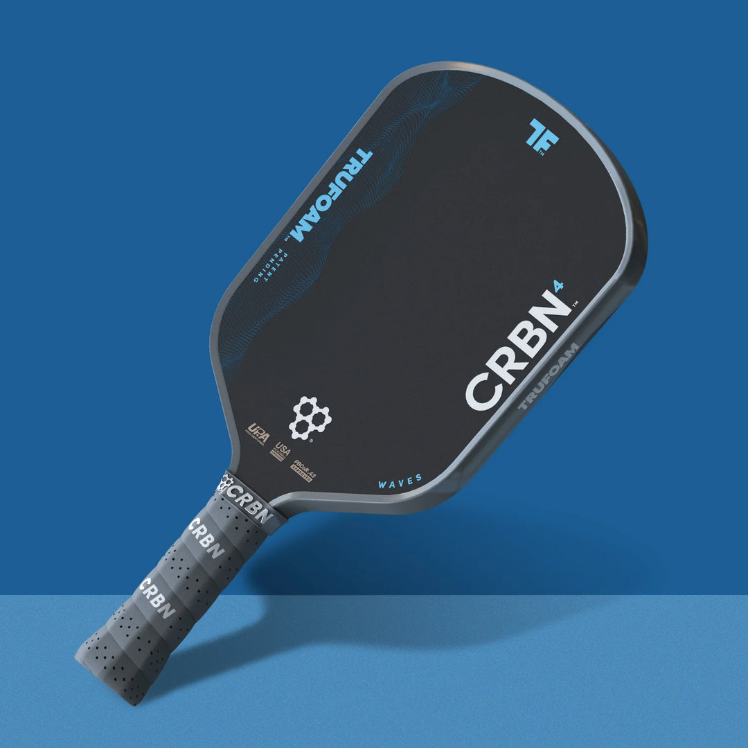 Black pickleball paddle with branding on a blue background