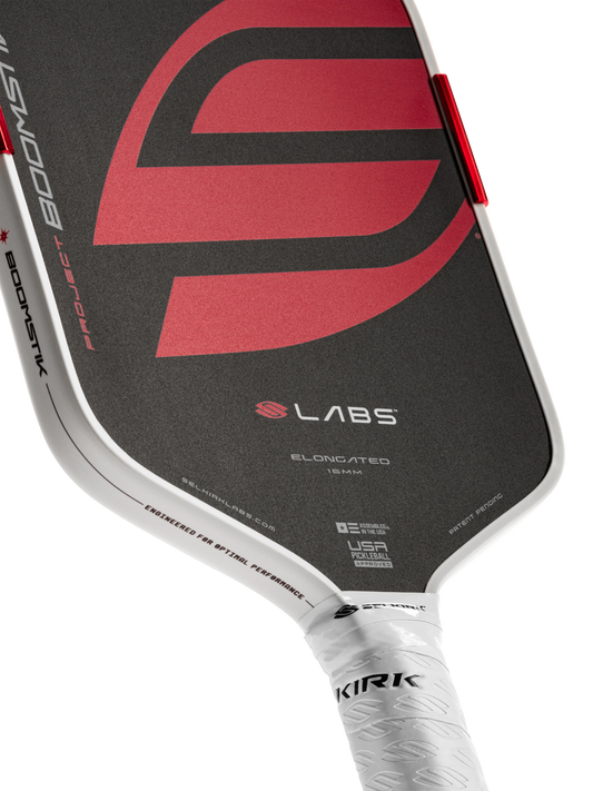 Close-up of a pickleball paddle with a red and black design on a white background