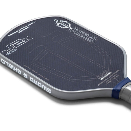 Close-up of a pickleball paddle with branding on a white background