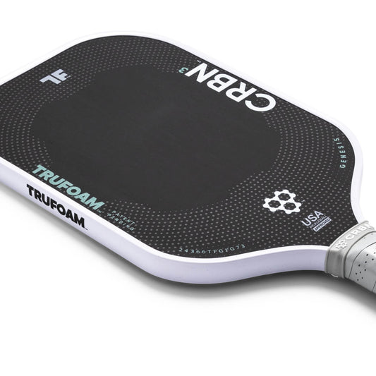 Close-up of a pickleball paddle with 'TRUFOAM' and 'CRBN' branding on a white background