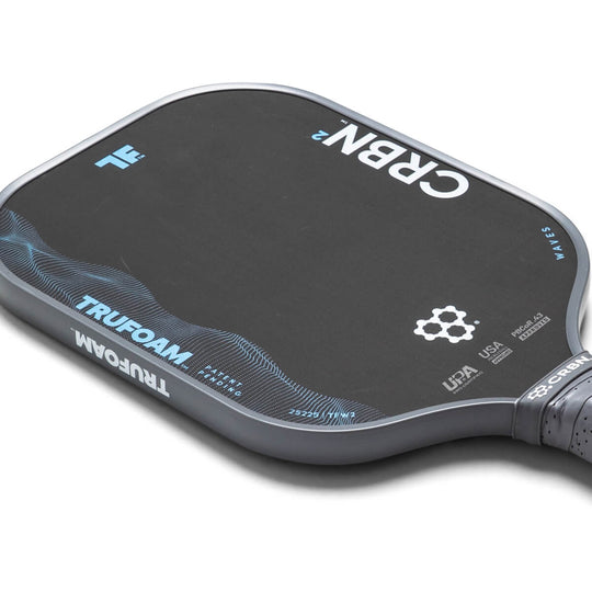 Close-up of a pickleball paddle with branding on a white background
