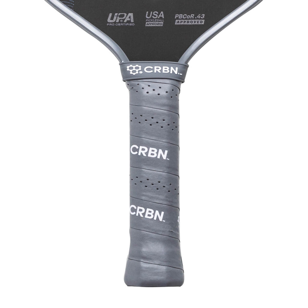 Close-up of a pickleball paddle with 'CRBN' branding on a white background