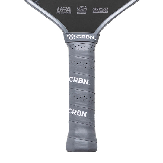 Close-up of a pickleball paddle with 'CRBN' branding on a white background