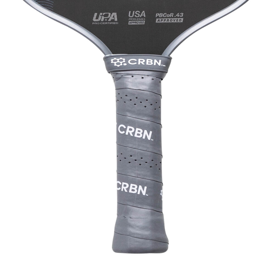 Close-up of a pickleball paddle with 'CRBN' branding on a white background