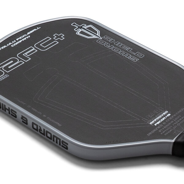 Close-up of a pickleball paddle with branding on a white background