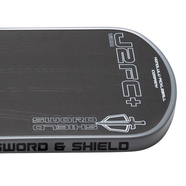 Black and gray pickleball paddle with 'Sword & Shield' branding on a white background