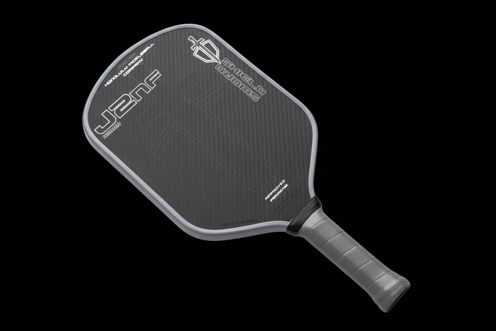 Black pickleball paddle with branding on a white background