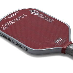 Red pickleball paddle with branding on a light red background