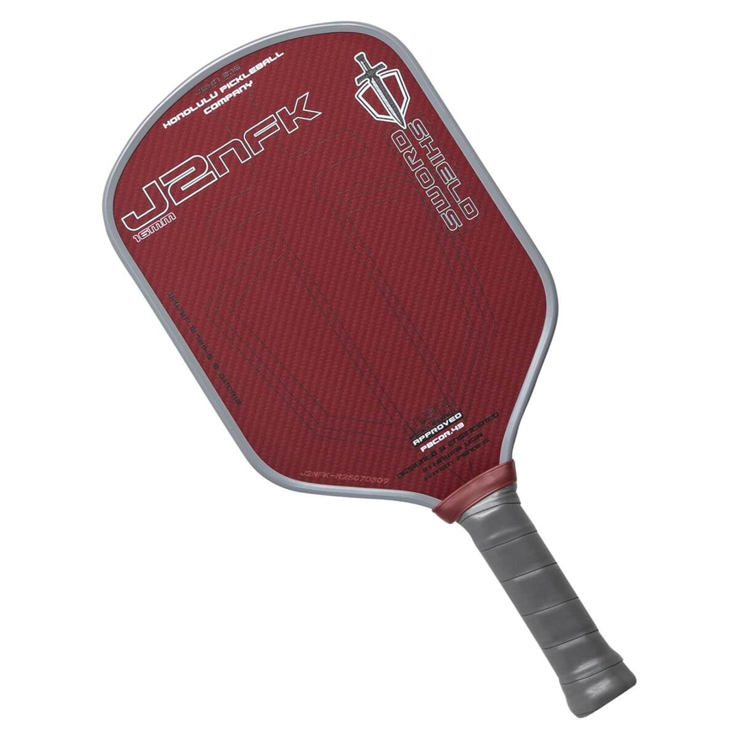 Red pickleball paddle with gray handle on a grat text