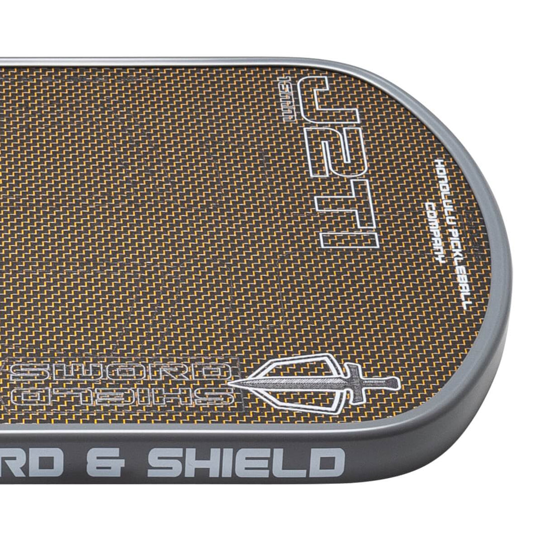 Close-up of a textured surface with 'Shield & Shield' branding on a white background