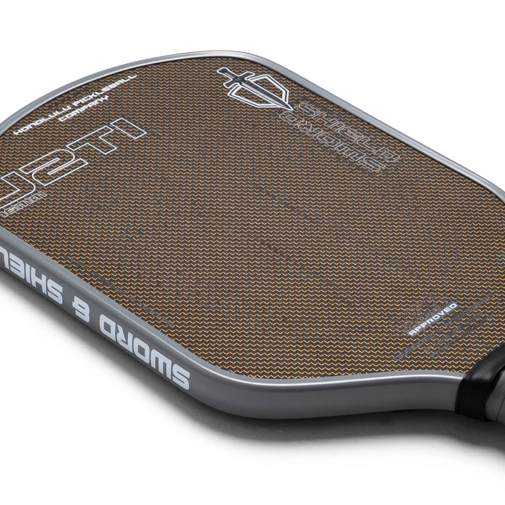 Close-up of a pickleball paddle with brand logos on a white background