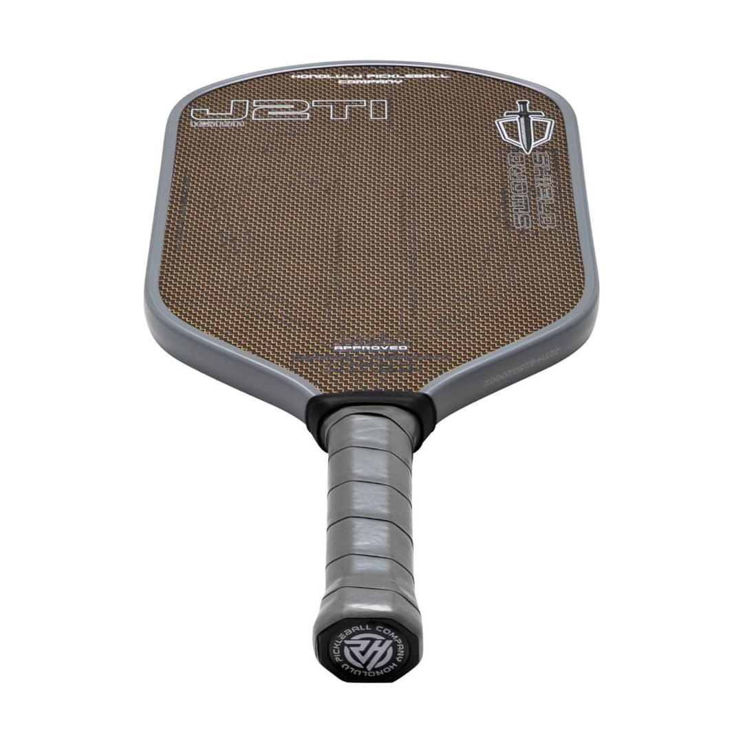 Pickleball paddle with brown playing surface and black handle on a white background